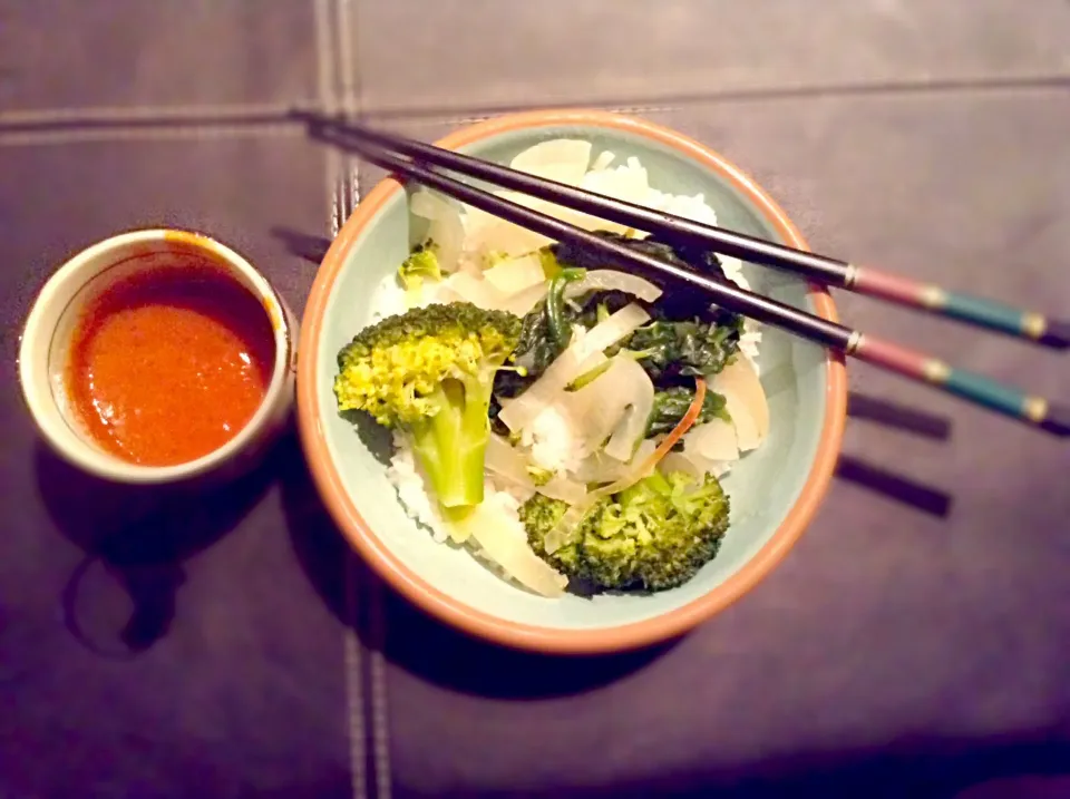 Steamed veggies on a bed of wet rice with spicy peanut satay sauce|elisha odegardさん