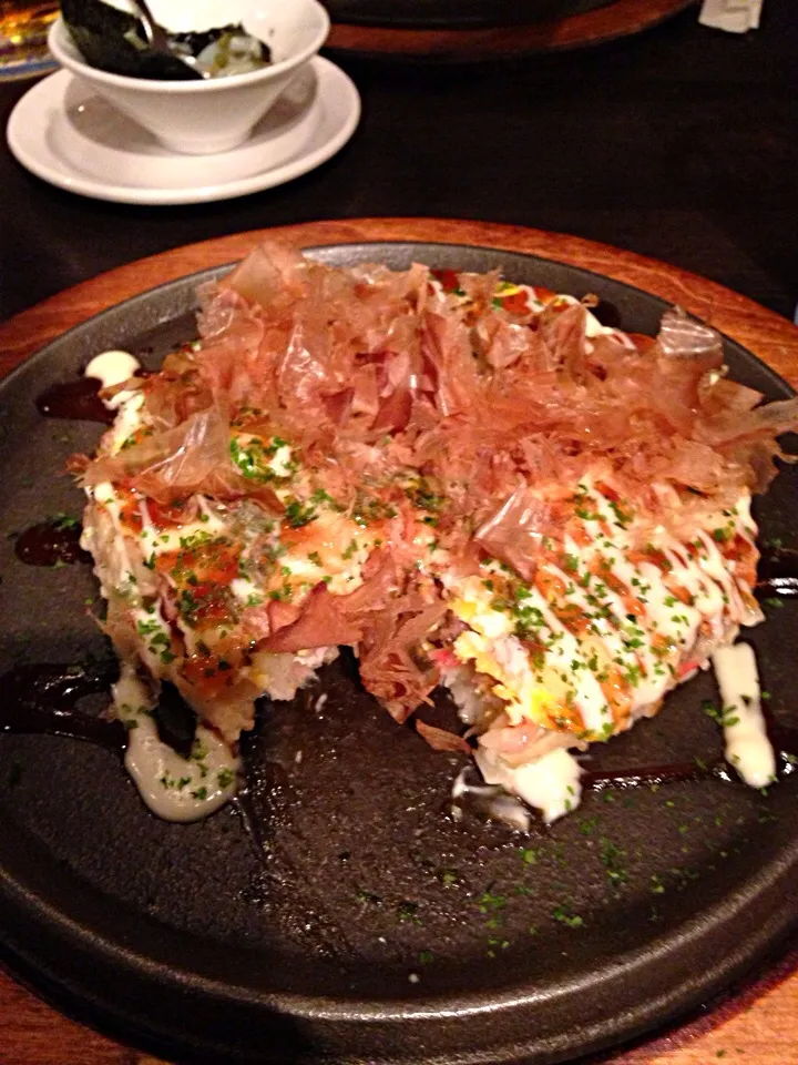 Pork okonomiyaki topped with katsuobushi. Takowasa in the background.|Seanさん