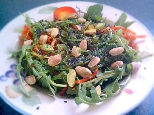 Snapdishの料理写真:Arugula with seaweed salad and shredded squid topped with sesame seeds & pistachios.|Jiraphon Gさん