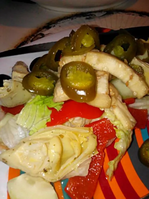 My salad with artichoke hearts, roasted reds, onion, cucs, olives, jalapenos, and strawberry preserve dressing.|Polly Gelfusoさん