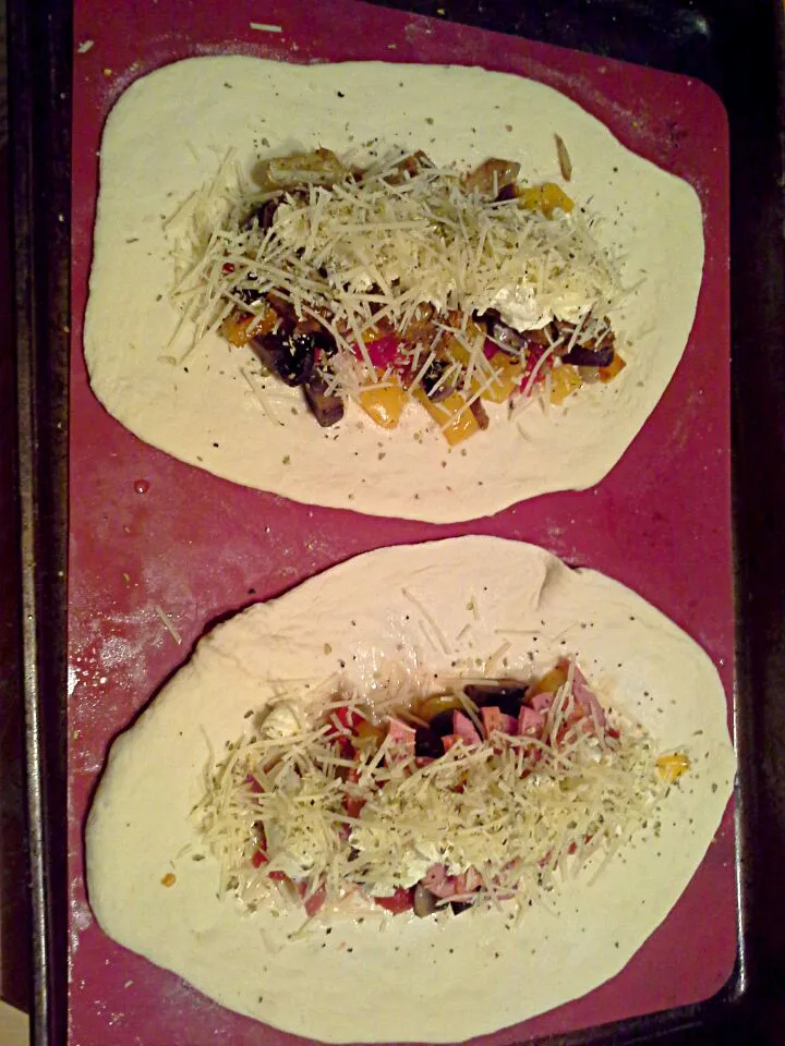 Roasted vegetable and sausage calzones.  One vegetarian.|Fe's kitchenさん