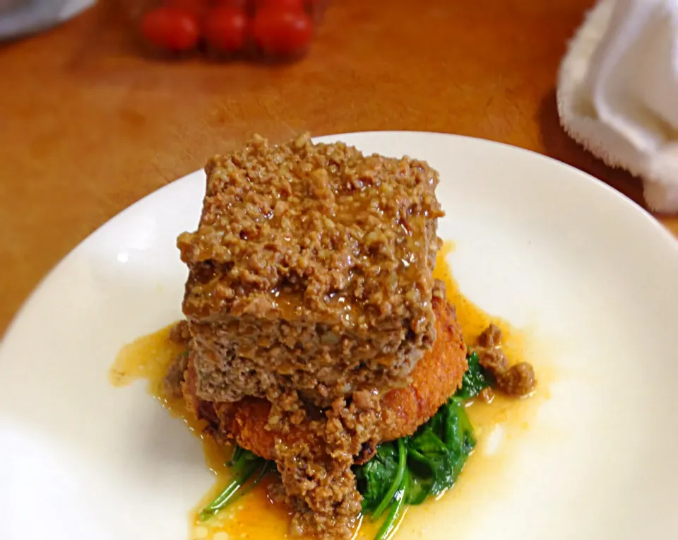 Snapdishの料理写真:3 meat meatloaf with a chorizo gravy along with a potato croquet (fried mash potato) and sautéed spinach.|Joeさん