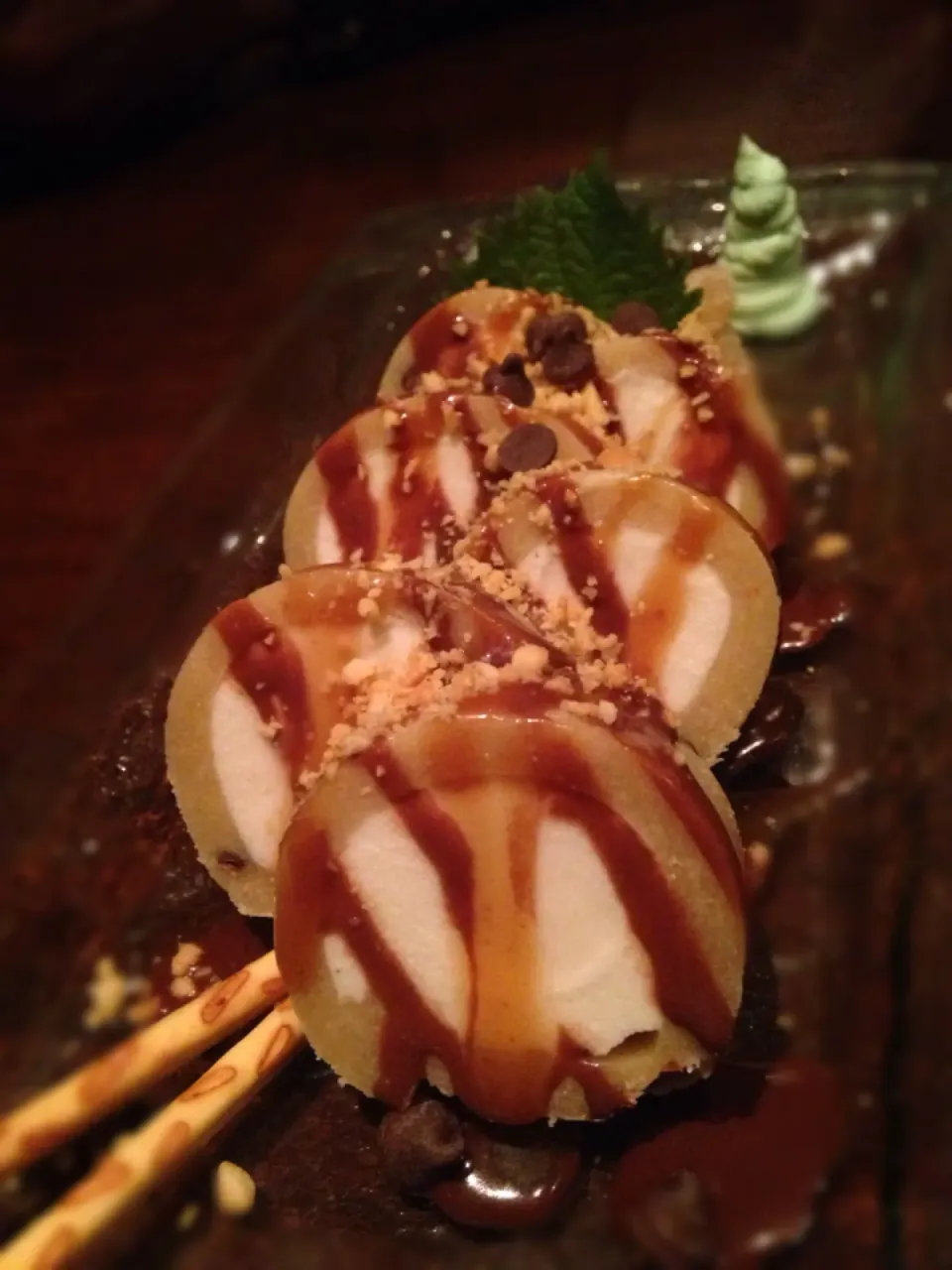 Snapdishの料理写真:Cookie Dough Sushi Roll wrapped around vanilla ice cream topped with caramel and chocolate sauce|robert flickerさん