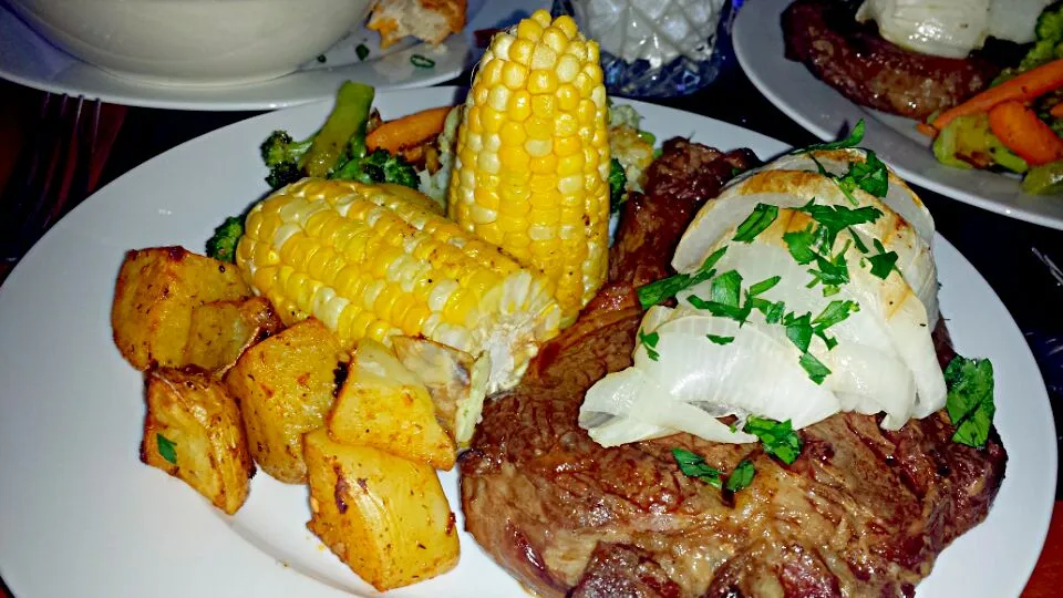 Garlic roasted potatoes,  Roasted mix veggies,  Corn and Ribeye steak with grilled onion.|Michael M Schleyerさん