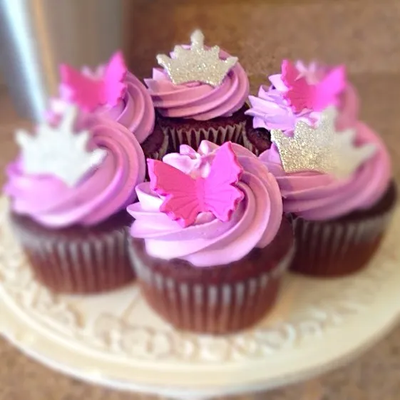 Snapdishの料理写真:Extra Choccy Cupcakes with pink swirl! Princess crowns & butterflys!!|Sugardaddy Rocksさん