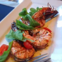 Tiger prawn grilled with garlic and topped with rockets