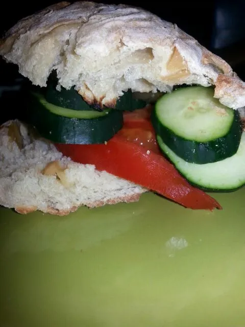 cucumber and tomato sandwich on garlic chibatta bread.|Polly Gelfusoさん