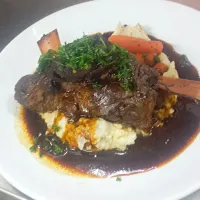 our Dr . Pepper lamb braised shanks on top of yummy mash potatoes and covered in its own lamb sauce|Steven Doportoさん