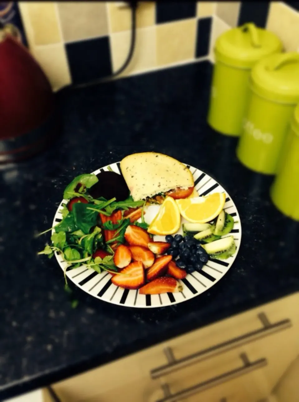 Snapdishの料理写真:Spicy chicken Harissa in Wholemeal Pitta, strawberries, salad, blueberrys, kiwi, orange segments, red pepper and beetroot.|niamh wilsonさん