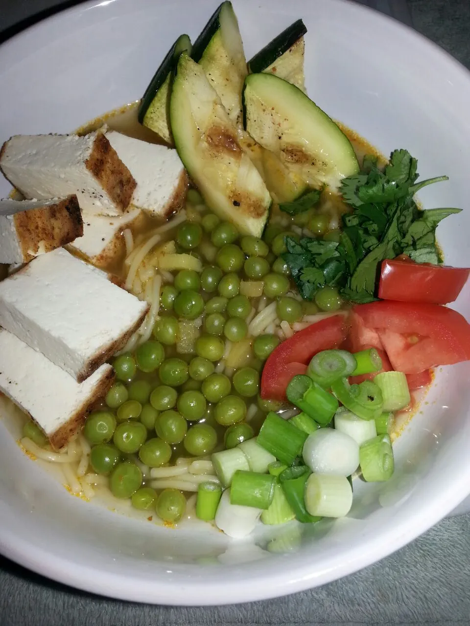 noodle soup with peas, grilled zucchini, tomato,  cilantro, grilled tofu.|Polly Gelfusoさん