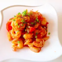 Stir fry prawns with tomatoes in garlic, oyster sauce and ketchup with a touch of sesame chili oil