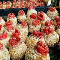 Local chinese snack made with sesame and glutinous rice flour fried in oil(煎堆). This traditional kind with the little red markings on top is usually found durin