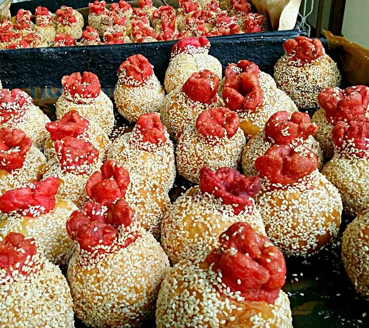 Local chinese snack made with sesame and glutinous rice flour fried in oil(煎堆). This traditional kind with the little red markings on top is usually found durin|Skyeさん