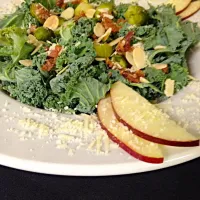 Snapdishの料理写真:Kale chopped salad with Brussel sprouts, toasted almonds, sliced apple, and house smoked bacon. Served with a maple almond vinaigrette.|Theran Conradさん