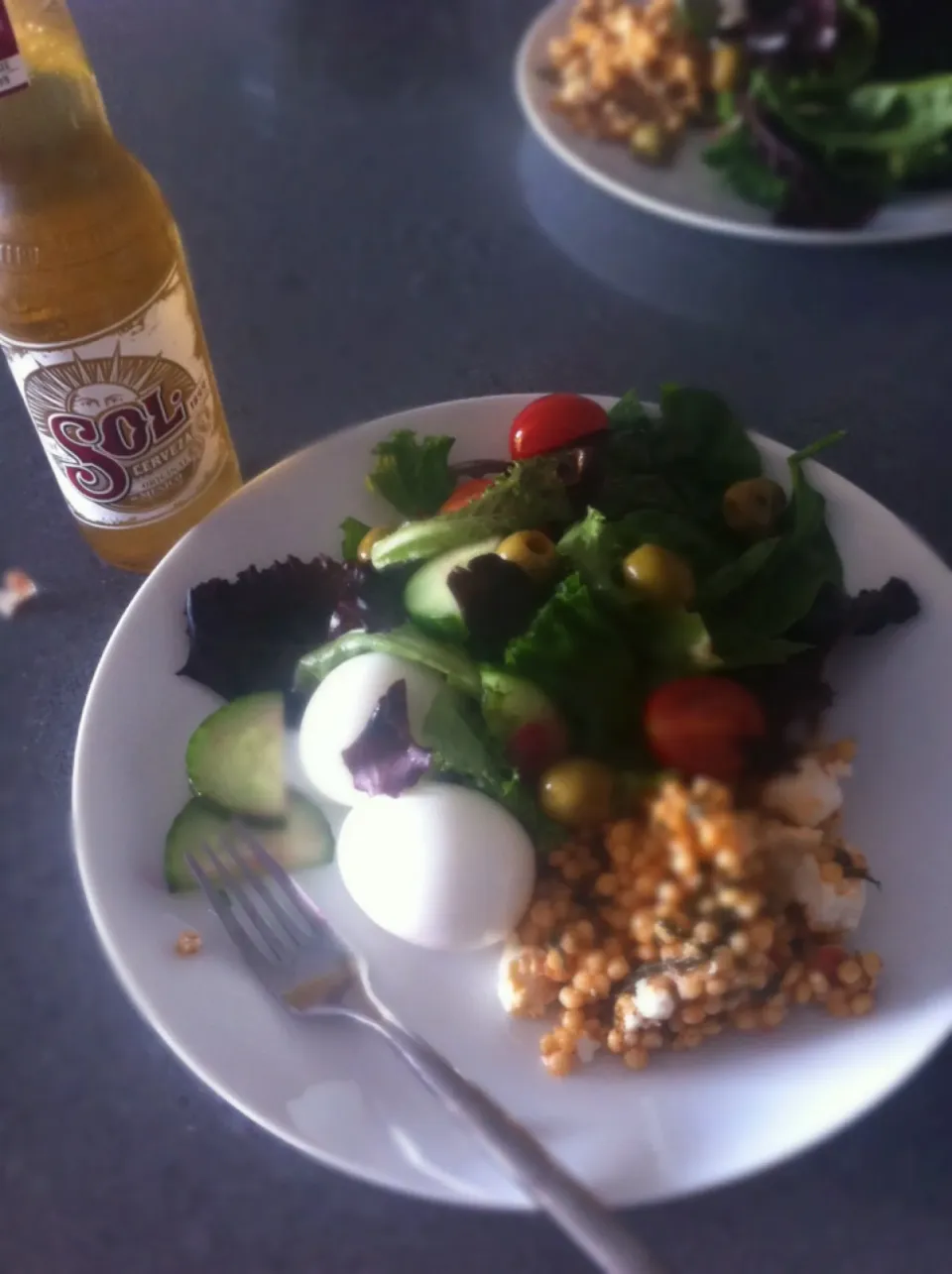 Salad with eggs, giant couscous and a Sol beer with lime wedge.|🍓Jolejo🍓さん