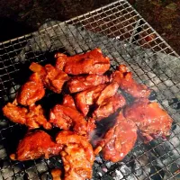 Basting and grilling spare ribs after slow cooking them in a Dutch oven