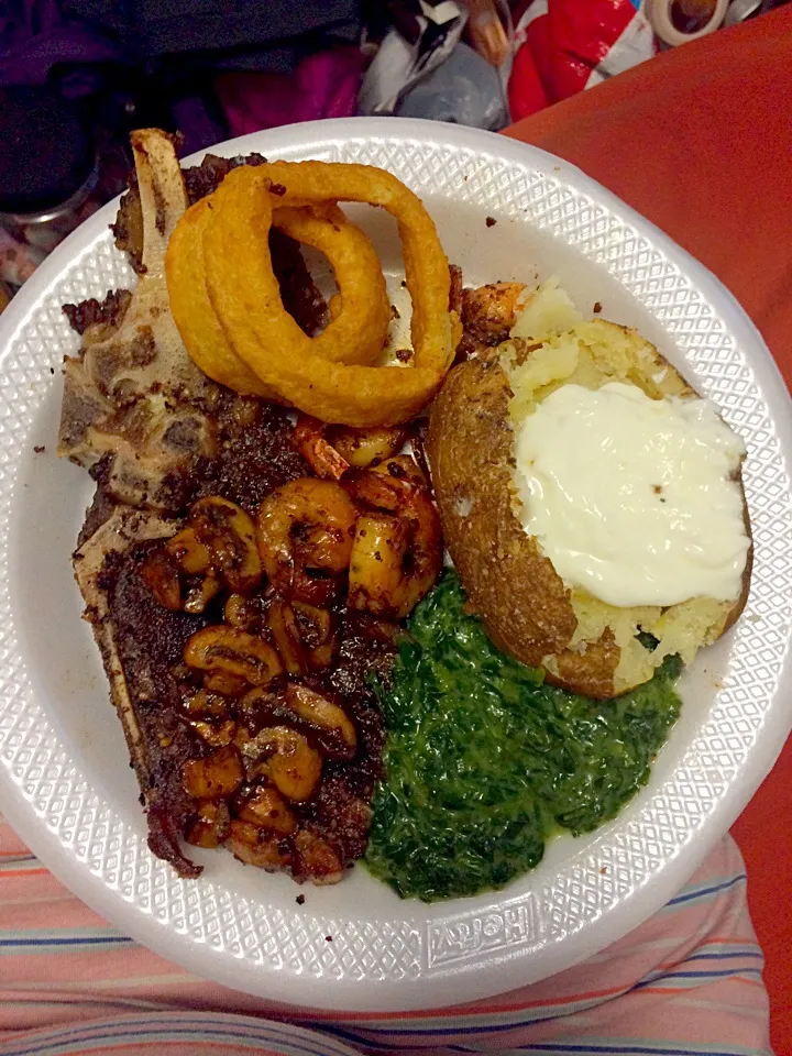 Pan seared steak with sautéed mushrooms, grilled shrimp,  creamed spinach, onion rings and a baked potato|MissKokoaさん