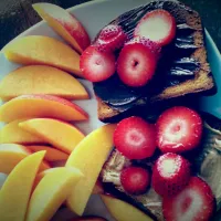 brown rice bread covered w/ nutella or peanut butter.  sliced strawberries and a peach. # breakfast|lucy hernandezさん