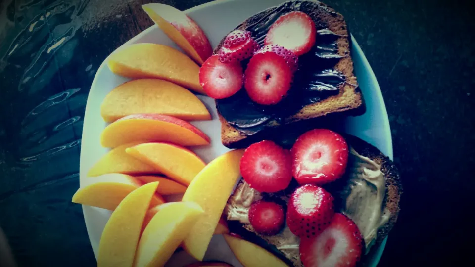 brown rice bread covered w/ nutella or peanut butter.  sliced strawberries and a peach. # breakfast|lucy hernandezさん