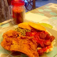 Snapdishの料理写真:Fried Pork Chops, Stewed Tomatos & Rice w/ Sausage,  Sweet Peas & Fried Hoecakes|FoodManOnWheelzさん