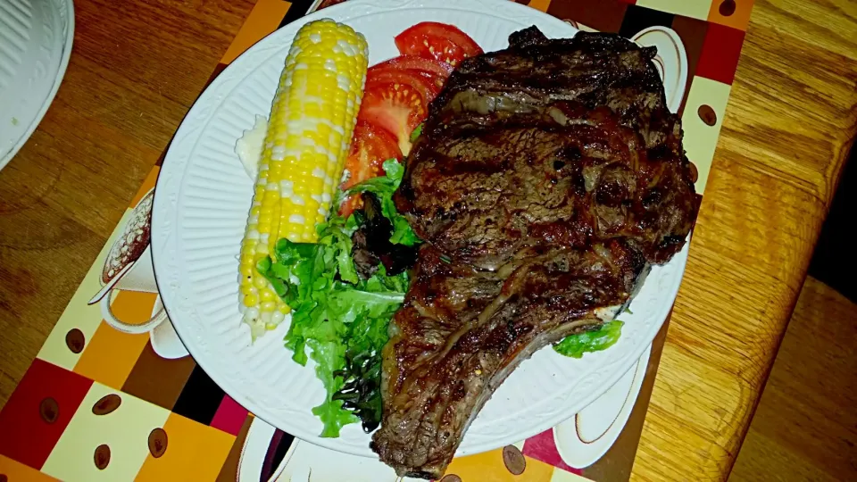 Snapdishの料理写真:Charcoal Cooked Rib Eye with corn on the cob with spring greens and tomatoes with balsamic.|Frank Ortizさん