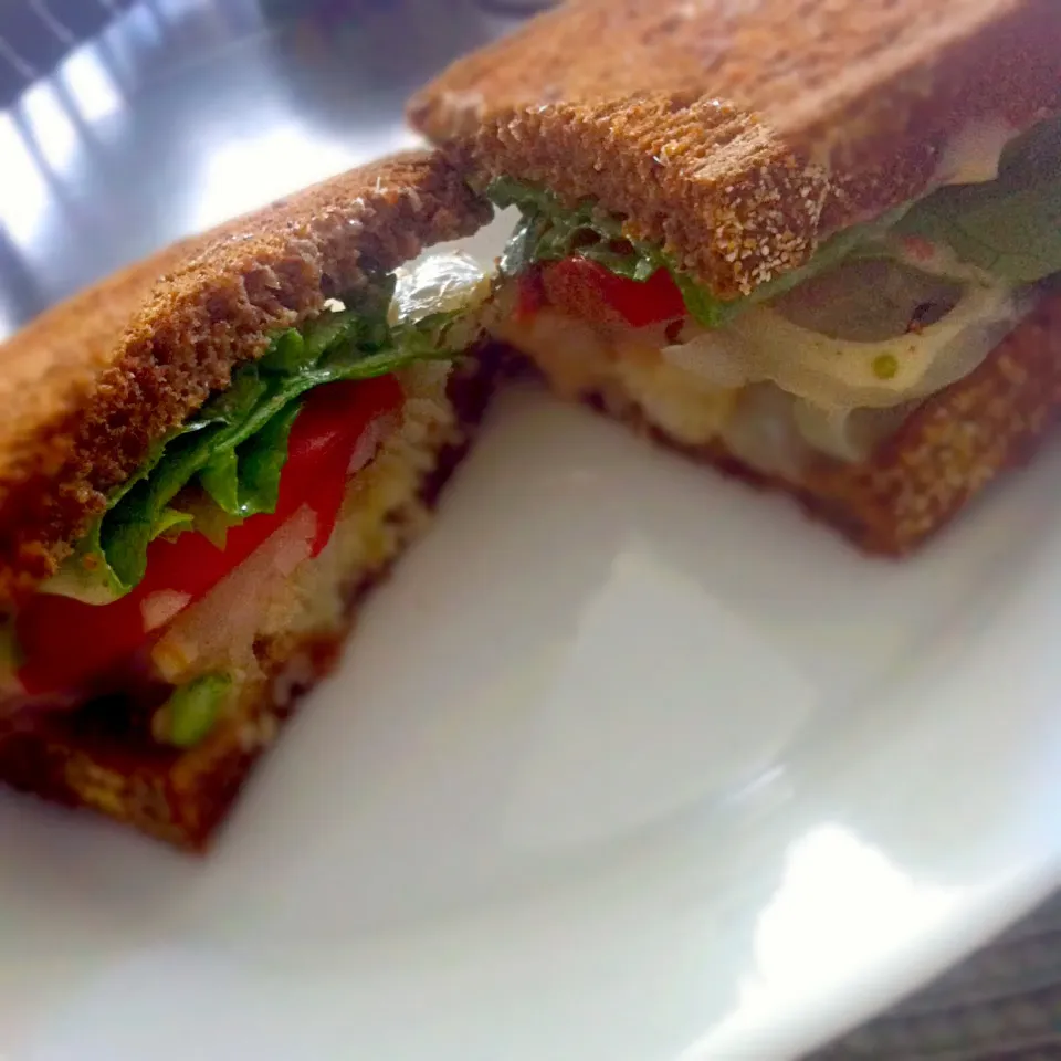 Baked Cod Sandwich smothered in Onions with tomato and Lettuce on toasted pumpernickel rye|T.E.Dennisさん