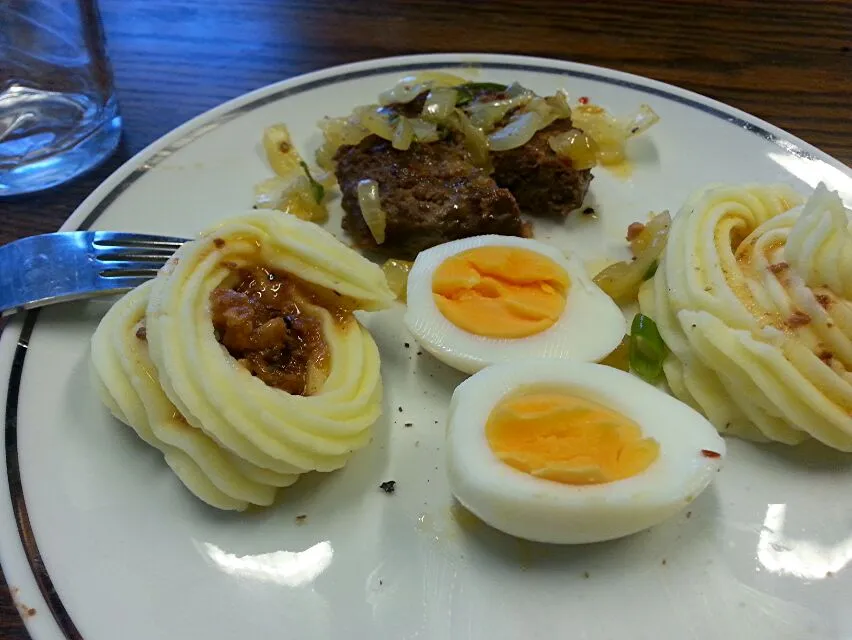 burger steak with onions and mashed potatoes topped with a boiled egg|Karolynn Bachmannさん