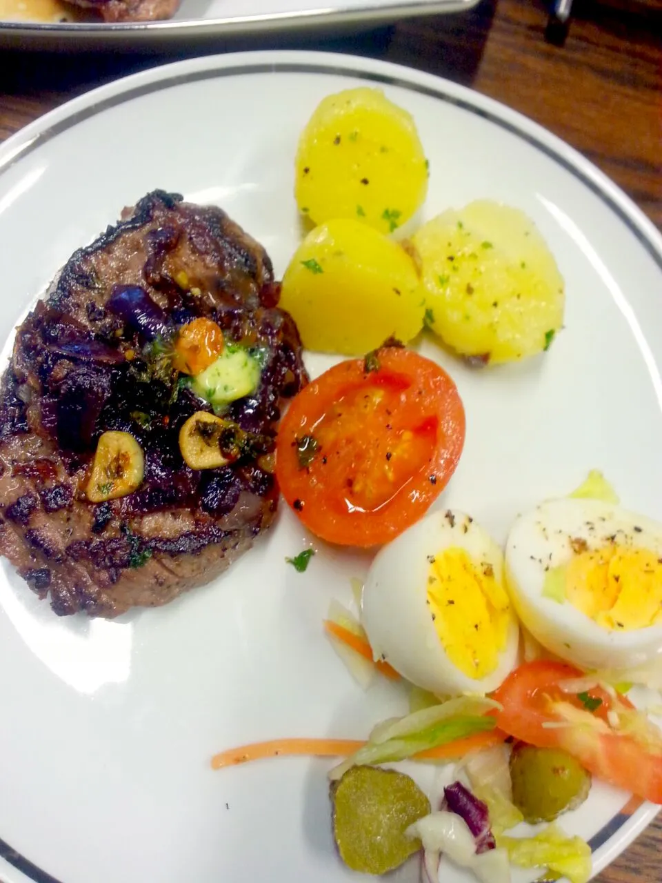 Snapdishの料理写真:steak with carmalized onions, rosted tomatoes, parsley and butter potatoes and a side salad with boiled egg|Karolynn Bachmannさん