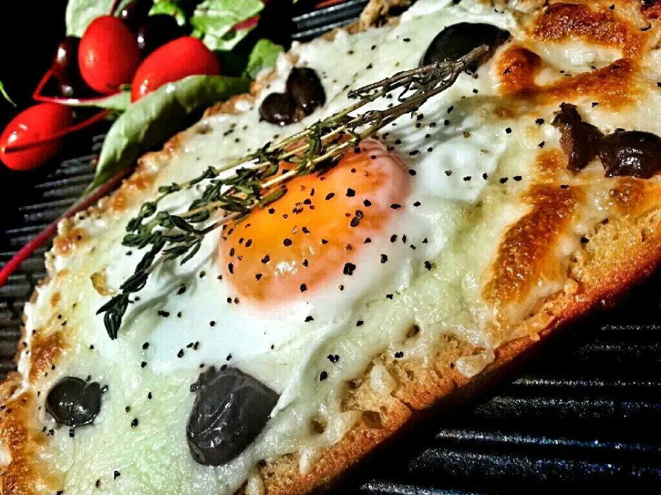 Snapdishの料理写真:baked eggs and mozzarella cheese on rustic rye bread with Greek olives.|Ahmedさん