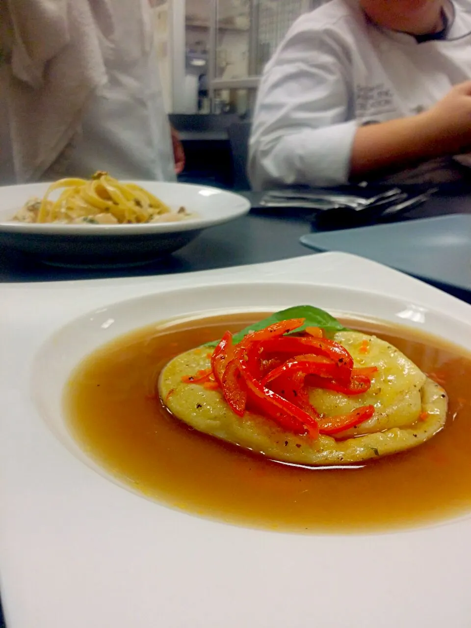 Goat cheese and blue cheese ravioli with oxtail broth and sautéed red bell pepper|Omar Mejiaさん