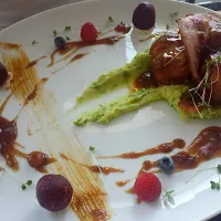 Pork filet wraped in bacon on a bed of pea&potato mash with apricot and peach sauce and summer veg salad.|Grzegorz Rydzewskiさん