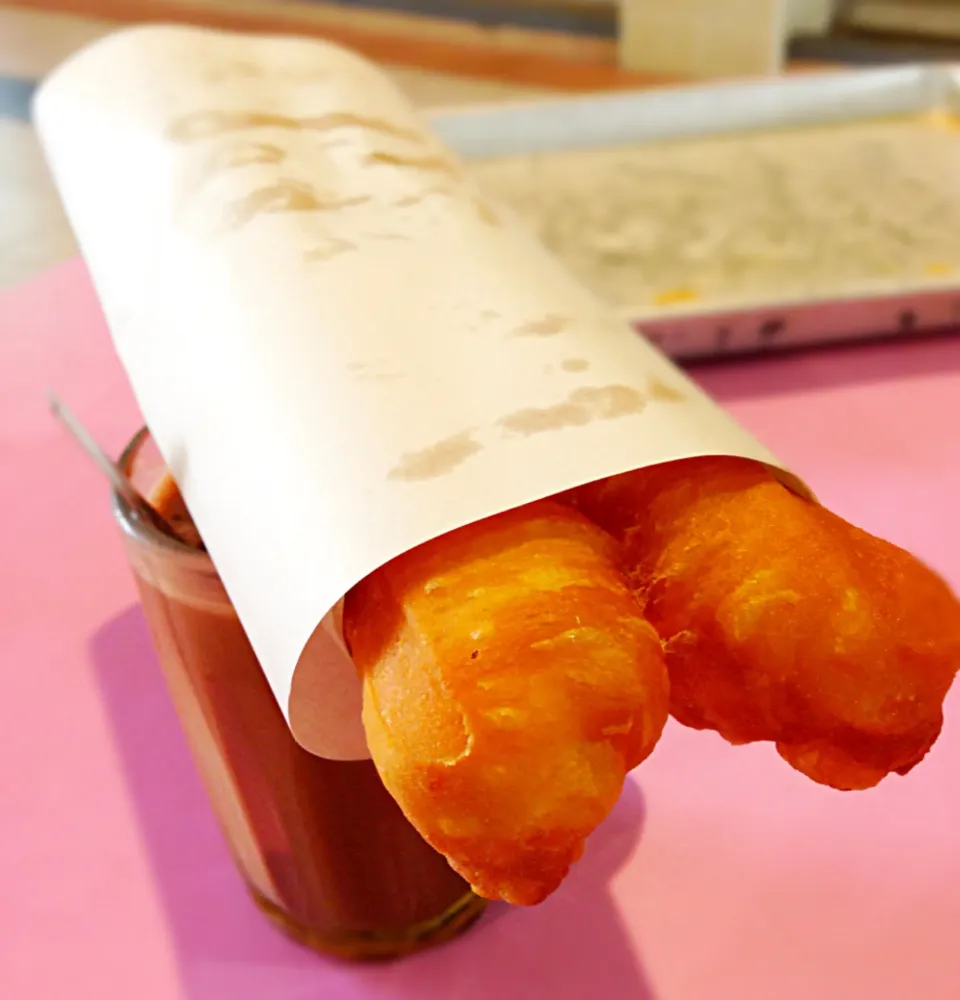 Traditional Sg way of breakfast - 油条(deep fried dough fritter) sitting on top of a cup of local kopi(coffee)|coxiella24さん