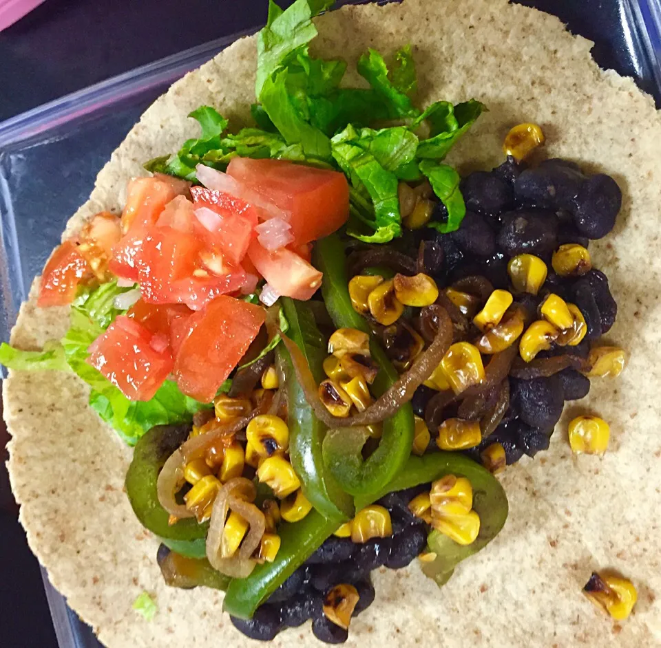 Snapdishの料理写真:Veggie Burrito with lettuce, pico de gallo, black beans and grilled peppers, onions, & corn on a whole wheat tortilla|victoria valerioさん