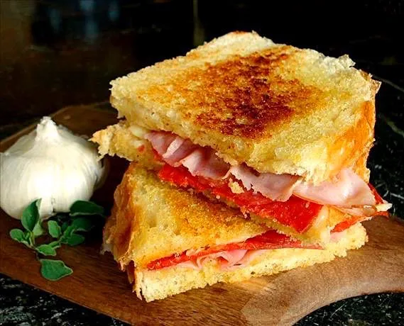 butter toasted bread with basil, herbs, garlic, red bell pepper cooked, bacon and cheddar cheese melt.|Andrew Martiniさん