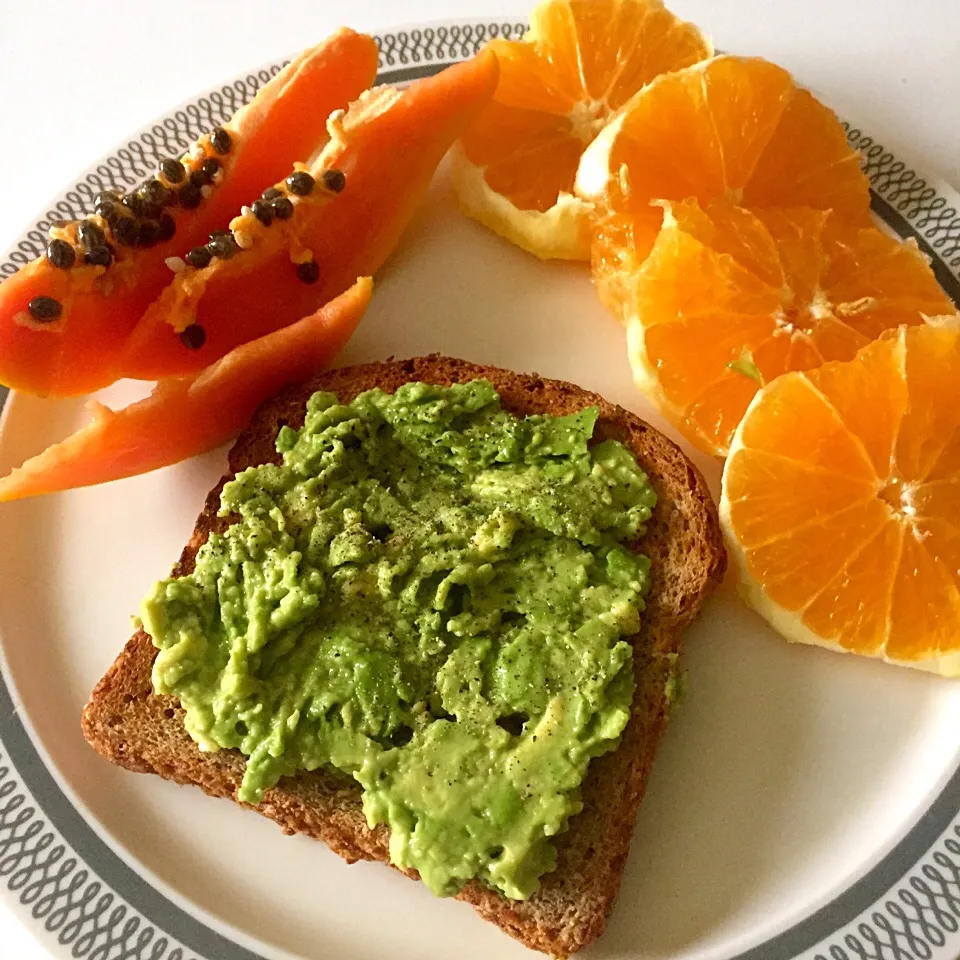 Ezekial toast with mashed avocado. Side of diced papaya and orange rings|victoria valerioさん