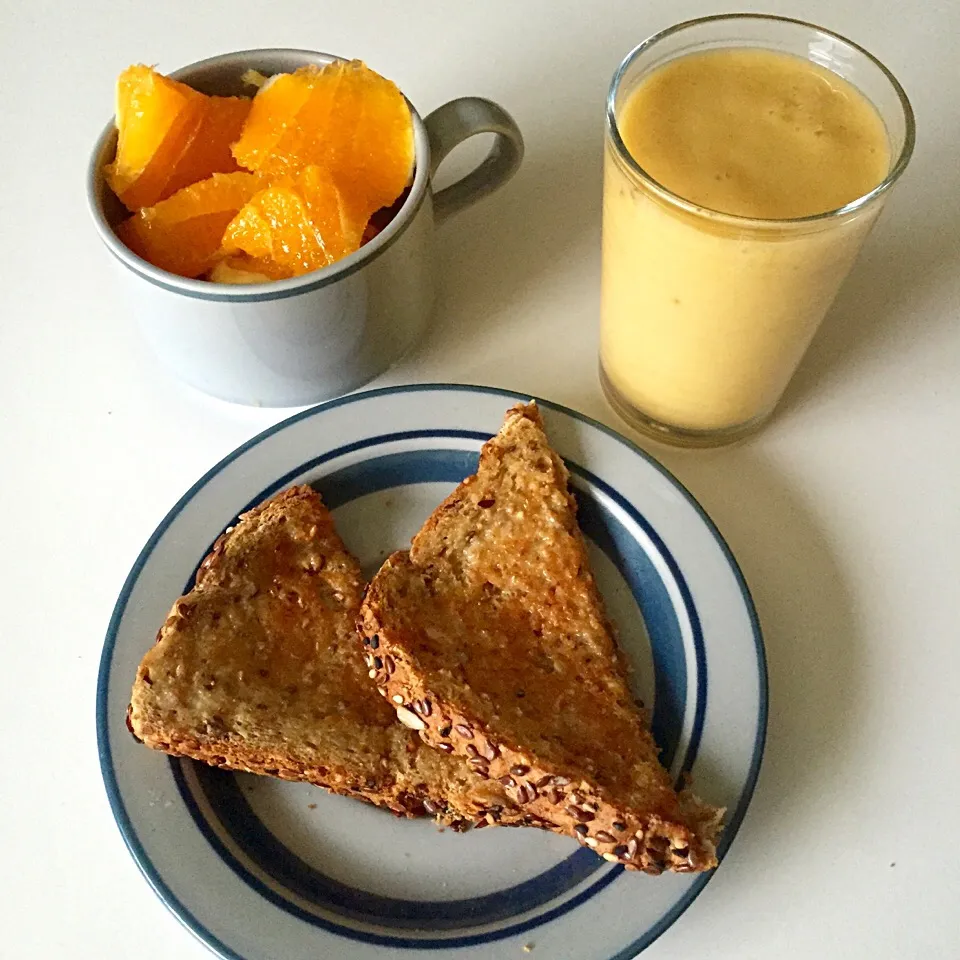 Mango & banana milkshake with oranges and dave's multi-seed toast spread with earth balance butter|victoria valerioさん