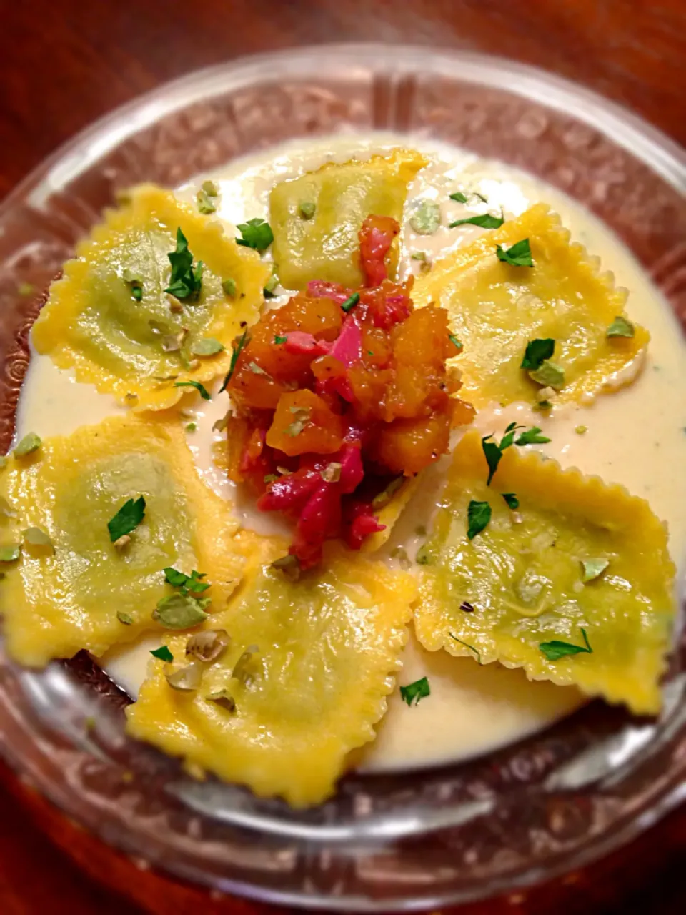 Arugula Parmesan ravioli in a parm cream sauce topped with pan seared prosciutto and roasted butternut squash In a Demi glacé. Garnish with edamame beans and pa|Troy Craneさん