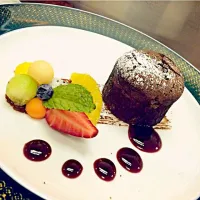 Chocolate Lava with Chocolate sauce serve with Mixed fruits.