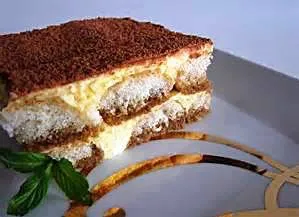 delicious tiramisu with mint leaves garnish.|Andrew Martiniさん