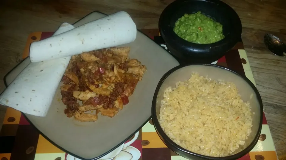 Snapdishの料理写真:YELLOW RICE GUACAMOLE MADE WITH RED ONION CILANTRO GARLIC LEMON JUICE SALT PEPPER CHICKEN AND CHORIZO IN A PEACH MANGO SAUCE  IN A WARP.|Frank Ortizさん