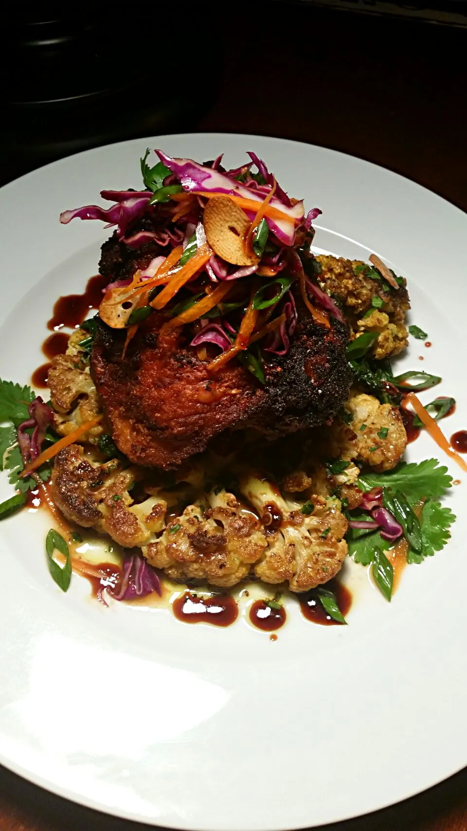 African spiced crispy chicken, with Harrisa, greens, Curry roasted cauliflower steak, and chili balsamic sauce.... crispy garlic slaw garnish.|Jenn Strangeさん