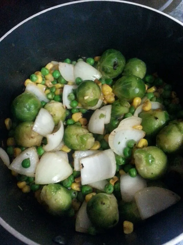 sauteeing onions,  brussel sprouts,  peas,  And corn for Tom yum soup.|Polly Gelfusoさん