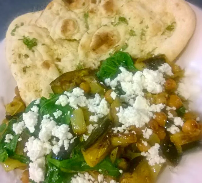 Curried eggplant with chickpeas & spinach topped with crumbled feta cheese eaten with garlic naan.|Jiraphon Gさん