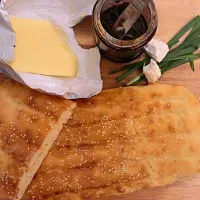 Homemade bread.  You eat it with sour cherry jam, feta cheese and butter|Emily Tanさん