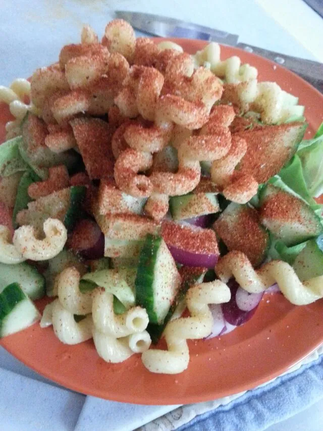 pre Dressed salad.  with Boston lettuce,  red onion,  cucumber,  And pasta.  made spicy with chili powder.|Polly Gelfusoさん