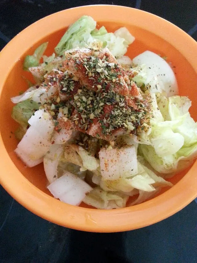 Snapdishの料理写真:my simple salad for today.  iceberg with onion, spices, lemon oil, and Apple cider vinegar.|Polly Gelfusoさん