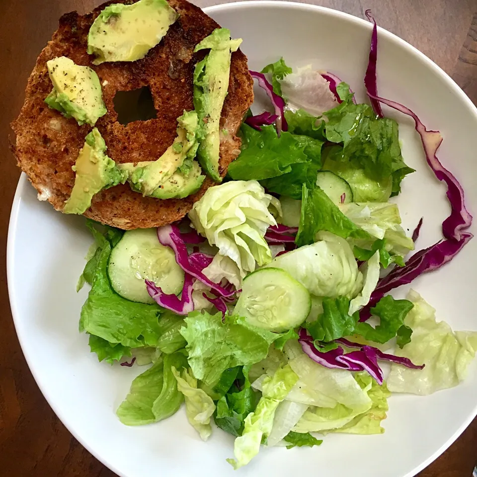 Whole grain bagel with earth balance butter and avocado with mixed green salad|victoria valerioさん