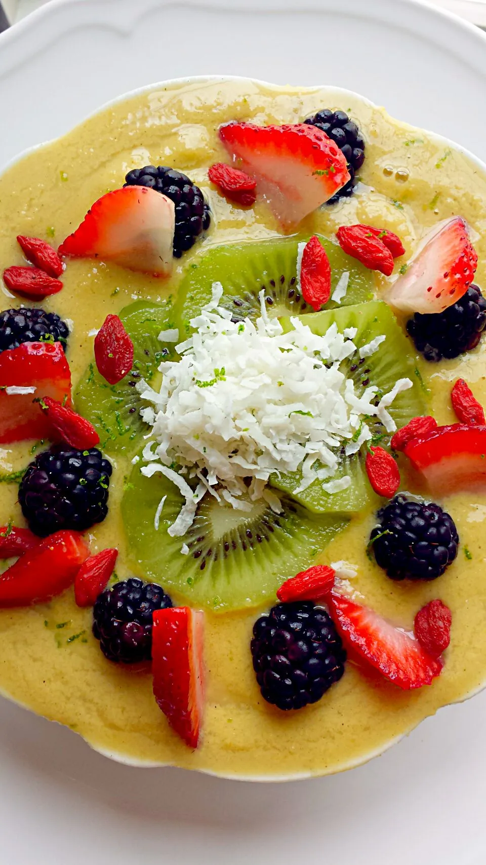 Snapdishの料理写真:Raw and Vega Mango Smoothie Bowl and topped with #gojiberries#kiwi#blackberries#coconut#strawberries.  #foodonIG #Foodphotography #foodie #veganfood #lunch #rec|lisaさん