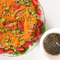 Snapdishの料理写真:Japanese inspired salad with ramen, edamame, carrot, tomato, baby spinach with a black sesame dressing