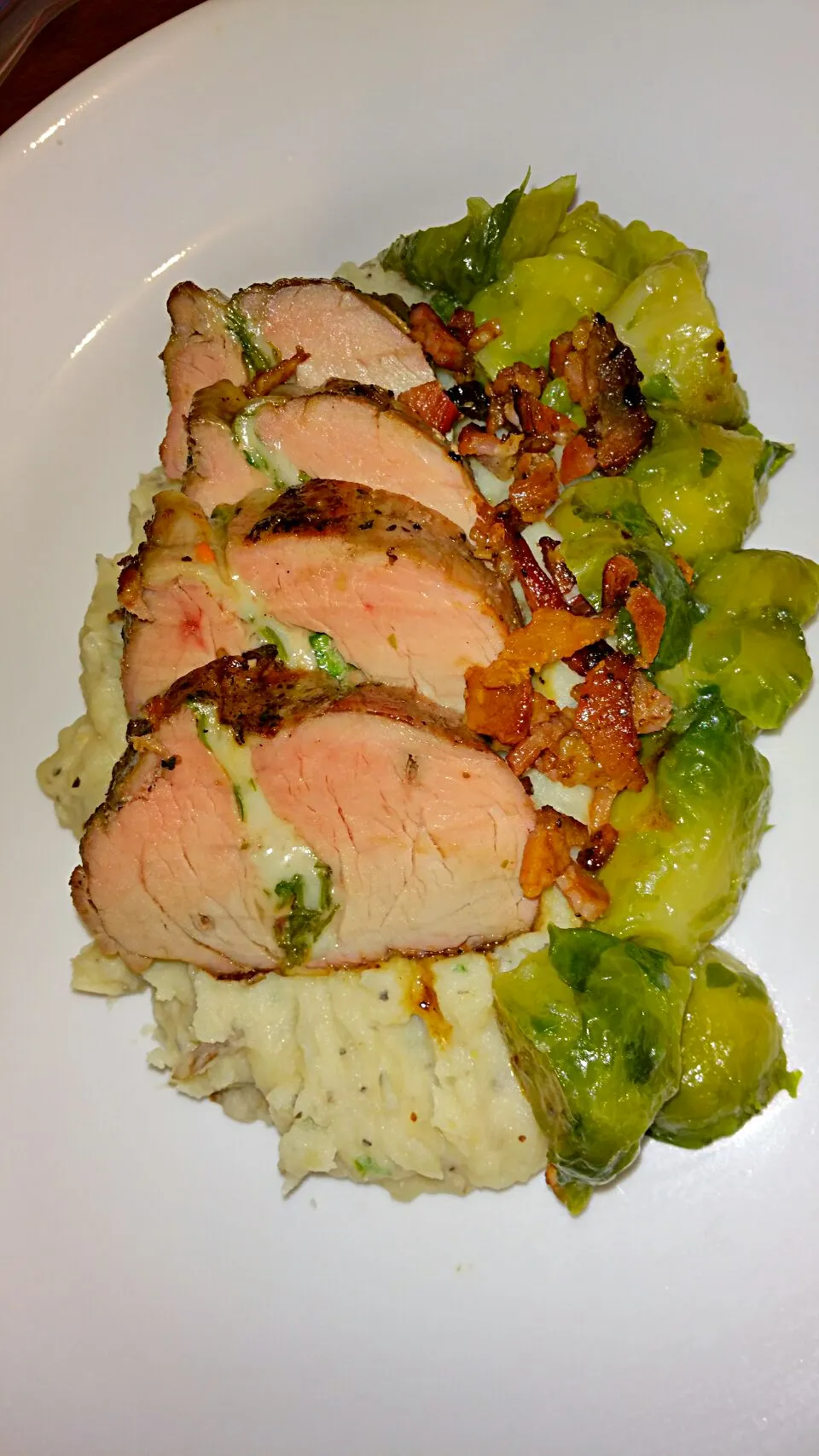 pork tenderloin stuffed with swiss cheese,  chard, spinach,  and kale with brussels and potato|Zachary Etheridgeさん